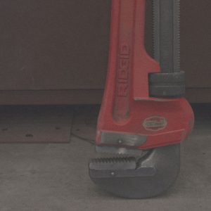 Close up of large adjustable wrench on shop floor